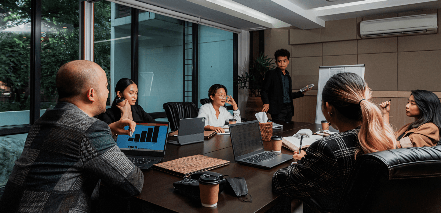 Business team collaborating around a laptop